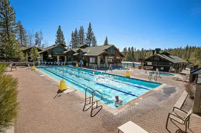a large swimming pool in front of a lodge at Sparrow's Rest by Tahoe Getaways - Pet-Friendly 3BR in Tahoe Donner w HOA in Truckee