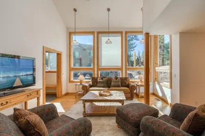 a living room with a couch and a tv at Sparrow's Rest by Tahoe Getaways - Pet-Friendly 3BR in Tahoe Donner w HOA in Truckee