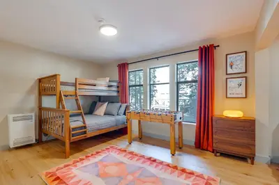 a bedroom with a bunk bed and a desk at Ski-InandSki-Out Retreat with Sauna in Bear Valley! in Bear Valley