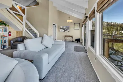 a living room with a couch and a window at Wooded Hilltop Stay Shared Hot Tub + Lake Views in Stateline