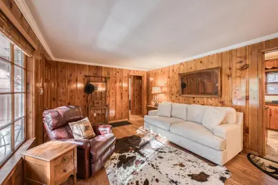 a living room with a couch and a chair at Diana's Cabin by Tahoe Getaways - Pet-Friendly 2BR in Kings Beach w Backyard & Walk to Lake! in Tahoe Vista