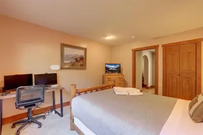 a bedroom with a bed and a desk with a computer at Knotty by Nature 3 bed home in South Lake Tahoe