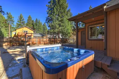 a hot tub in the backyard of a house at Knotty by Nature 3 bed home in South Lake Tahoe