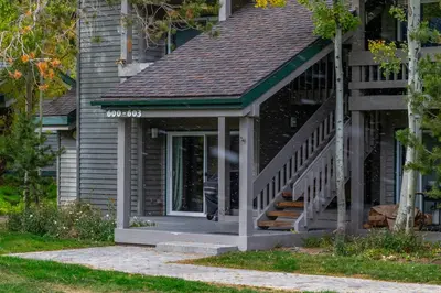 a front porch of a house with a staircase at Tranquil & Woodsy 2/2 Retreat – Jacuzzi, W/D, BBQ! in Mammoth Lakes