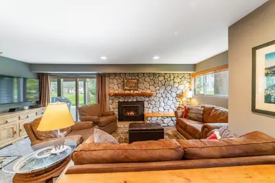 a living room with leather furniture and a fireplace at Tranquil & Woodsy 2/2 Retreat – Jacuzzi, W/D, BBQ! in Mammoth Lakes