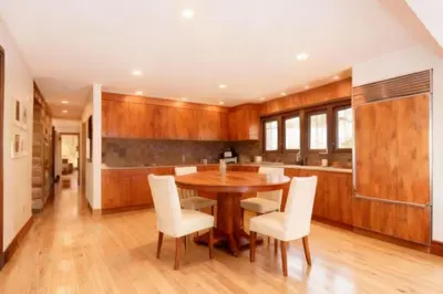 a kitchen with a wooden table and white chairs at Mammoth Lakes Alpine Stay in Mammoth Lakes