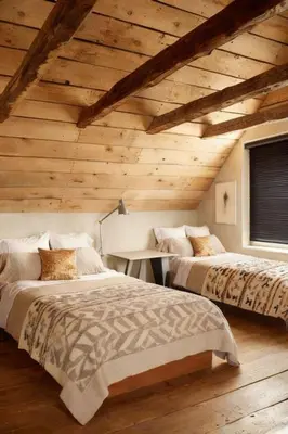 two beds in a room with wooden ceilings at Mammoth Lakes Alpine Stay in Mammoth Lakes