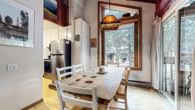 a dining room with a wooden table and a refrigerator at Horizons 4 120 Great Complex Amenities, On The Shuttle Route, Walk To Shops and Restaurants condo in Mammoth Lakes