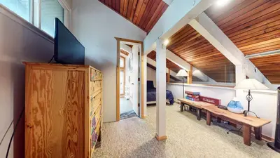 a living room with a tv and a wooden ceiling at Horizons 4 120 Great Complex Amenities, On The Shuttle Route, Walk To Shops and Restaurants condo in Mammoth Lakes