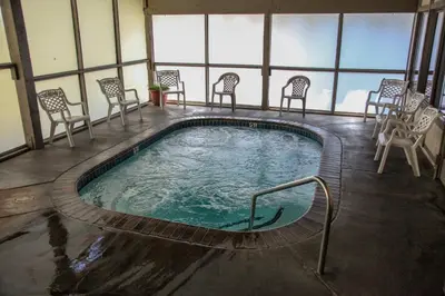 a swimming pool in a building with chairs around it at Horizons 4 120 Great Complex Amenities, On The Shuttle Route, Walk To Shops and Restaurants condo in Mammoth Lakes