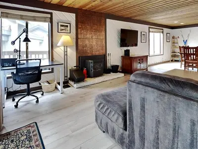 a living room with a couch and a desk at Slopeside Condo With Fireplace Snowbird 112 At 1849 Condos in Mammoth Lakes
