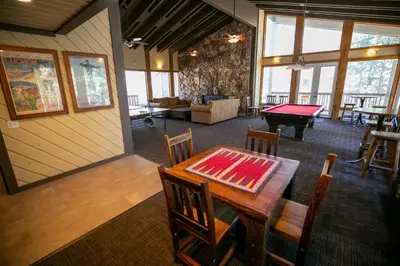 a living room with a table and a pool table at Slopeside Condo With Fireplace Snowbird 112 At 1849 Condos in Mammoth Lakes
