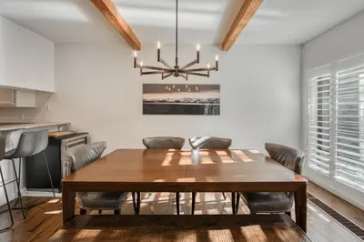 a dining room with a wooden table and chairs at Ridge Court # 13 by Tahoe Getaways - 3BR Palisades at Alpine Condo w Ski Shuttle & Tennis! in Alpine Meadows