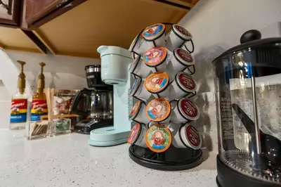 a vase with stickers on it sitting on a kitchen counter at 