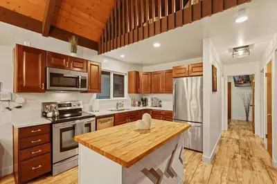 a kitchen with wooden cabinets and a wooden counter top at 