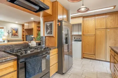 a kitchen with wooden cabinets and a stove at North Shore - Forest Haven in Kings Beach