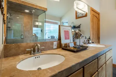 a bathroom with two sinks and a large mirror at North Shore - Forest Haven in Kings Beach