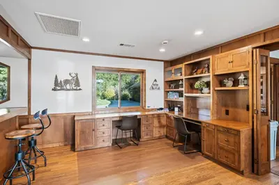 a home office with wooden cabinets and a desk at Mountain Oasis-Indoor Hot Tub, Game Room, VIEWS in Oakhurst