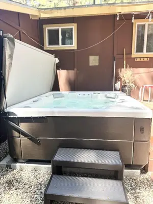 a hot tub sitting in front of a house at CYH0822 - Pinter Pines Retreat home in South Lake Tahoe