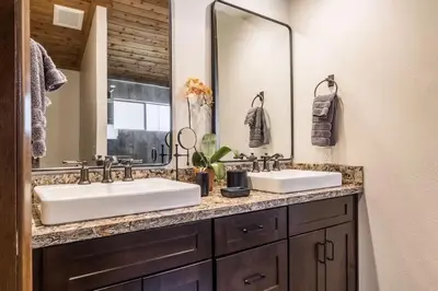 a bathroom with two sinks and a large mirror at Spacious 3BD & Loft Villa - Convenient to Slopes in Mammoth Lakes