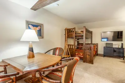 a dining room with a table and chairs and a bunk bed at Lodges 1178 - Timber Lodge Retreat in Mammoth Lakes