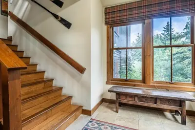 a staircase with a bench and a window at Lodges 1178 - Timber Lodge Retreat in Mammoth Lakes