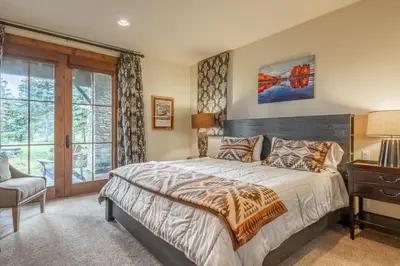 a bedroom with a bed and a desk and a window at Lodges 1178 - Timber Lodge Retreat in Mammoth Lakes