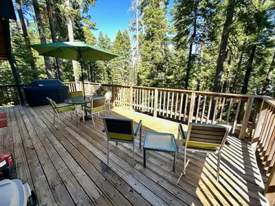 a deck with chairs and a table and an umbrella at Tahoe Park HOA l Palisades l Hot Tub l Dogs OK in Tahoe City