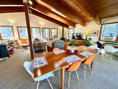 a living room with a wooden table and chairs at Tahoe Park HOA l Palisades l Hot Tub l Dogs OK in Tahoe City