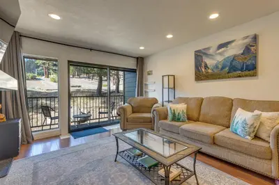 a living room with a couch and a table at Mammoth Mtn Ski-InandOut Condo with Hot Tub Access! in Mammoth Lakes