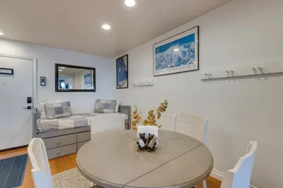 a dining room with a table and a couch at Mammoth Mtn Ski-InandOut Condo with Hot Tub Access! in Mammoth Lakes