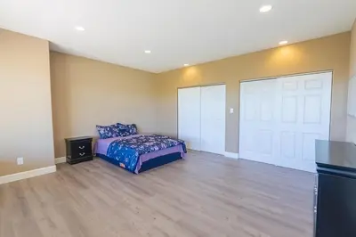a bedroom with a bed and two white garage doors at Sierra Vista Retreat - Reno Tahoe in Reno
