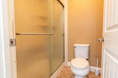 a bathroom with a toilet and a glass shower door at Sierra Vista Retreat - Reno Tahoe in Reno