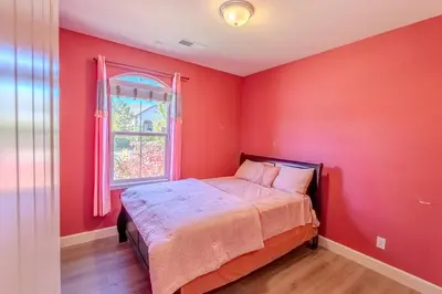 a red bedroom with a bed and a window at Sierra Vista Retreat - Reno Tahoe in Reno