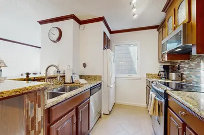 a kitchen with a sink and a refrigerator at Summit & Shore Chalet in Tahoe Vista