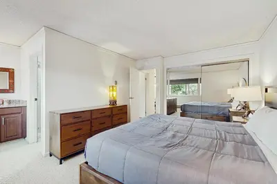 a bedroom with a bed and a dresser and a mirror at Summit & Shore Chalet in Tahoe Vista