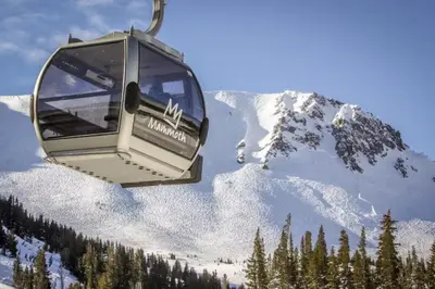 a gondola is flying over a snow covered mountain at Hidden Valley 114 I in Mammoth Lakes