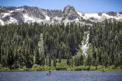 two people in a lake with mountains in the background at Hidden Valley 114 I in Mammoth Lakes