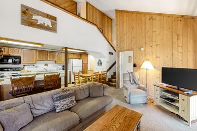 a living room with a couch and a kitchen at Hidden Valley 114 I in Mammoth Lakes