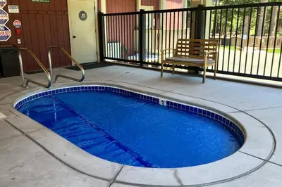 a small blue swimming pool with a bench next to it at Hidden Valley 26 D in Mammoth Lakes