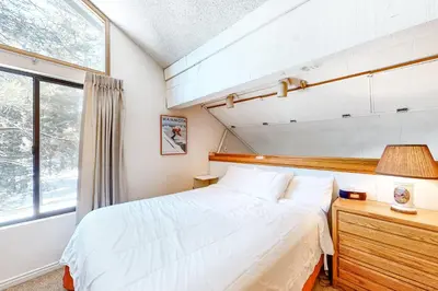 a bedroom with a large bed and a window at Hidden Valley 26 D in Mammoth Lakes