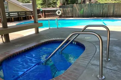 a swimming pool with blue water and metal rails at Hidden Valley 39 E in Mammoth Lakes
