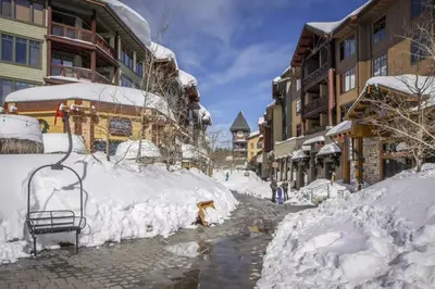 a street covered in snow next to some buildings at Hidden Valley 39 E in Mammoth Lakes