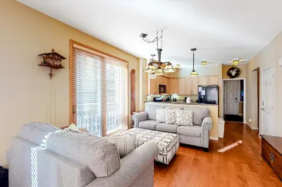 a living room with two couches and a kitchen at Mammoth Green 116 in Mammoth Lakes