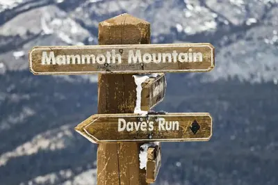 two signs on a pole with a mountain at Hidden Valley 14 B in Mammoth Lakes