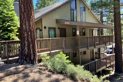 a house with a wrap around porch with trees at Hidden Valley 30 D in Mammoth Lakes