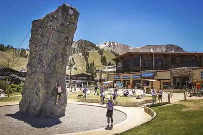 a group of people playing on a rock wall at Hidden Valley 30 D in Mammoth Lakes
