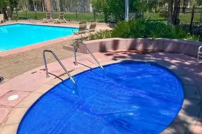 a large swimming pool with a blue pool at Mammoth Green 219 in Mammoth Lakes