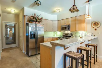 a kitchen with wooden cabinets and stainless steel appliances at Mammoth Green 110 in Mammoth Lakes