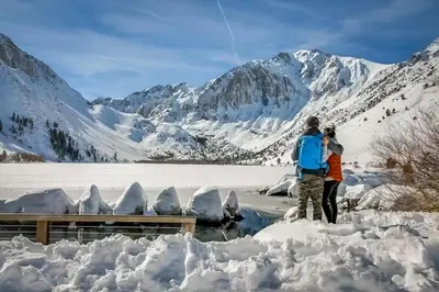 a man and a woman standing in the snow at Mammoth Green 110 in Mammoth Lakes